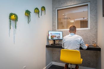 A man sitting at a desk in front of a computer